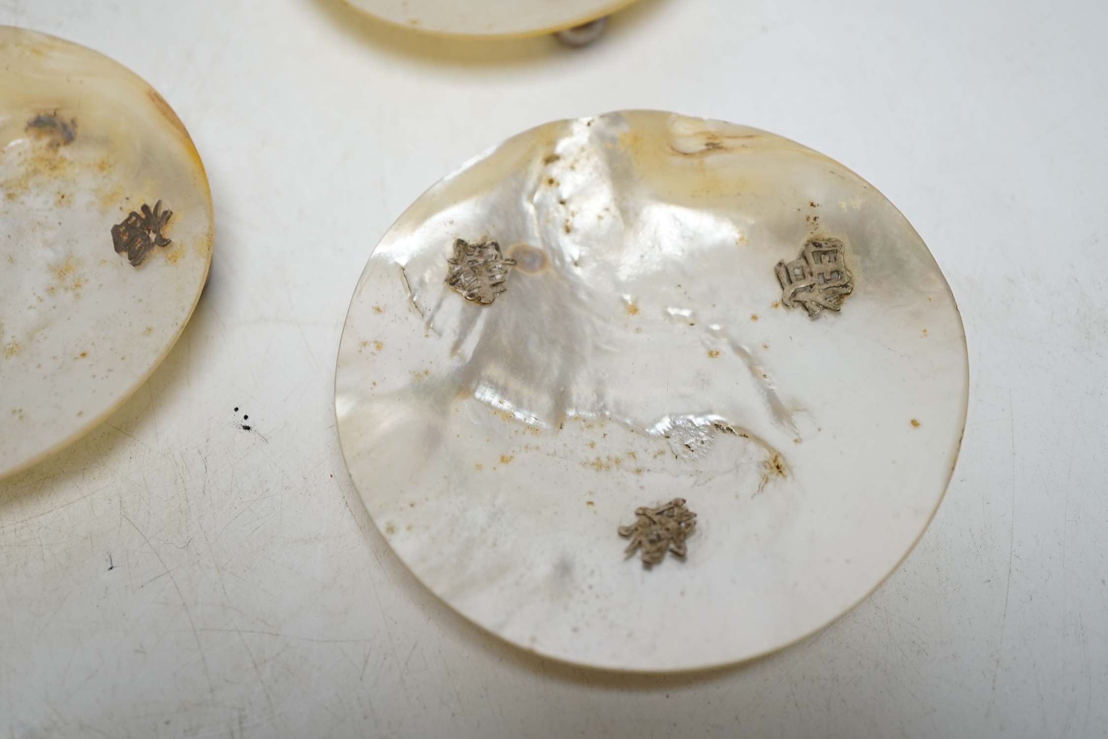 Six Chinese mother-of-pearl dishes on metal ball feet, largest 17.5cm wide. Condition - two ball feet missing on both larger shell dishes
